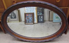 An oak framed wall mirror together with a papyrus painting