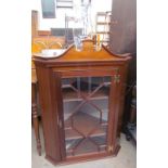A reproduction mahogany hanging corner cupboard with an astragal glazed door,