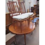 A mid-20th century teak dining table and three chairs