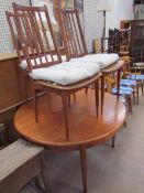 A mid-20th century teak dining table and three chairs