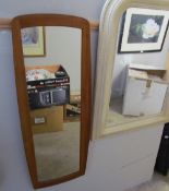 A teak framed wall mirror together with a cream wall mirror