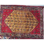 A rug with an orange angled central medallion,