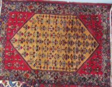 A rug with an orange angled central medallion,