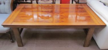 A rosewood coffee table of rectangular form on rectangular legs