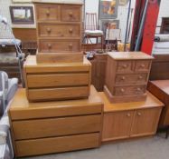 Two oak chests of drawers together with a pair of pine bedside chests of drawers together with a