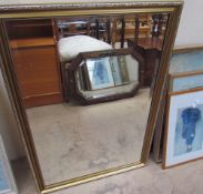 A gilt framed wall mirror together with assorted prints