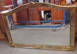 A gilt decorated overmantle mirror with a leaf moulded cresting