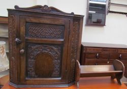 A small oak hanging corner cabinet together with a table top bookcase