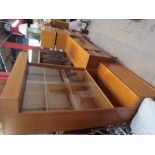 A teak wall unit together with a teak sideboard