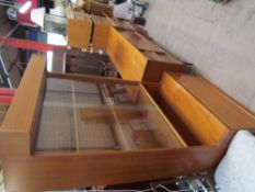 A teak wall unit together with a teak sideboard