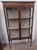 An Edwardian mahogany display cabinet, the rectangular top above a marquetry frieze,