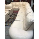 A large Natuzzi cream leather corner suite,