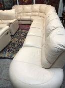 A large Natuzzi cream leather corner suite,