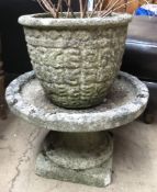 A reconstituted stone planter and bird bath