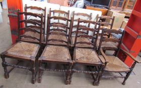 A set of seven ladder back dining chairs with rush seats together with a similar elbow chair