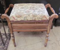 A piano stool with a pad seat and turned legs