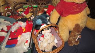 A large Pooh teddy bear together with other teddy bears and Christmas decorations