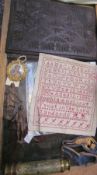 A late 19th century alphabetical sampler together with carved wooden book cover, a Limoges brooch,