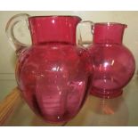 A pair cranberry glass jugs