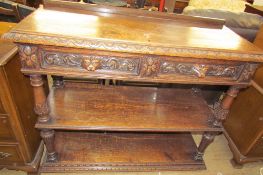 A 19th century Low Countries oak buffet with a rectangular carved top inset with drawers above a