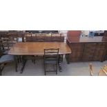 An Ercol style dark oak dining table,