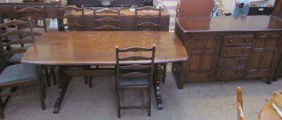 An Ercol style dark oak dining table,