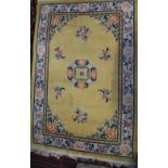 A Chinese rug, yellow field with central medallion in ivory foliate main border,