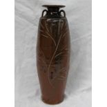 A studio pottery twin handled vase, with a brown ground and incised leaf and floral decoration,