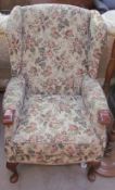 A floral upholstered wing back armchair