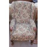 A floral upholstered wing back armchair