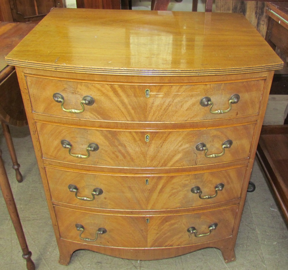 A Georgian style mahogany bow front chest of a small size with four long drawers on splayed feet,