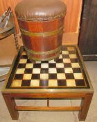 A brass bound oak coal bucket with a pad seat together with a brass bound chess table