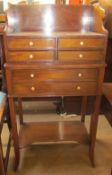 A reproduction mahogany side cabinet with six drawers on square legs united by an undertier