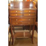 A reproduction mahogany side cabinet with six drawers on square legs united by an undertier