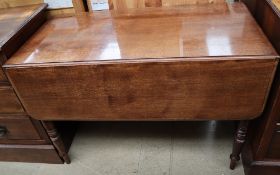 A Victorian mahogany Pembroke table with a rectangular top and drop flaps on turned legs