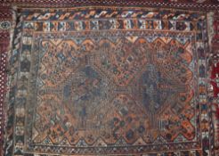 A rug with an orange ground and twin geometric medallions