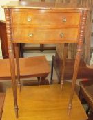 A late 19th century mahogany bedside table of serpentine outline having two drawers on reeded legs,