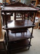 A reproduction mahogany whatnot with a carved back and four shelves