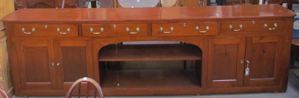 A 20th century stained pine sideboard of larger size and rectangular form,