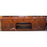 A 20th century stained pine sideboard of larger size and rectangular form,