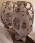 A pair of pottery twin handled vases,