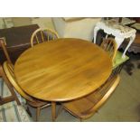 A mid-20th century teak dining table and four chairs together with a nest of tables and a dressing