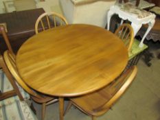 A mid-20th century teak dining table and four chairs together with a nest of tables and a dressing