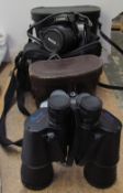 A Canon Eos 1000F 35mm camera together with a pair of Omiya 10 x 50 binoculars and a pair of Regent