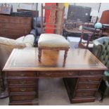 A 20th century oak pedestal desk with a leather inset top above a central drawer and two banks of