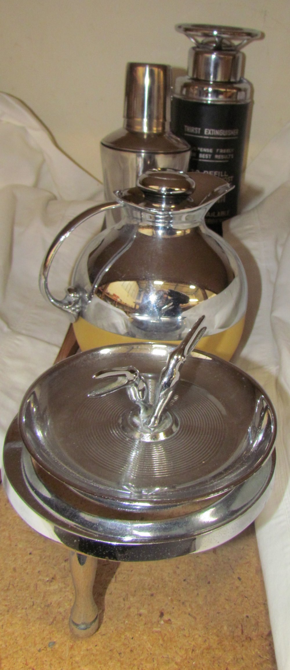 A Briggs national tyre service chrome ashtray together with chrome teapot stand,