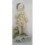 A Chelsea / Derby figure of a boy draped in cloth on a flower encrusted base