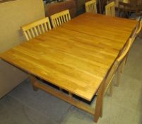 A 20th century light oak extending dining table,