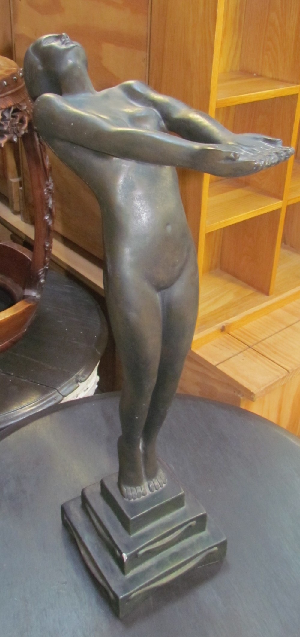 An Art Deco style plaster figure of a maiden on a stepped square base