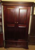 A 20th century mahogany wardrobe with a pair of cupboard doors and base drawers